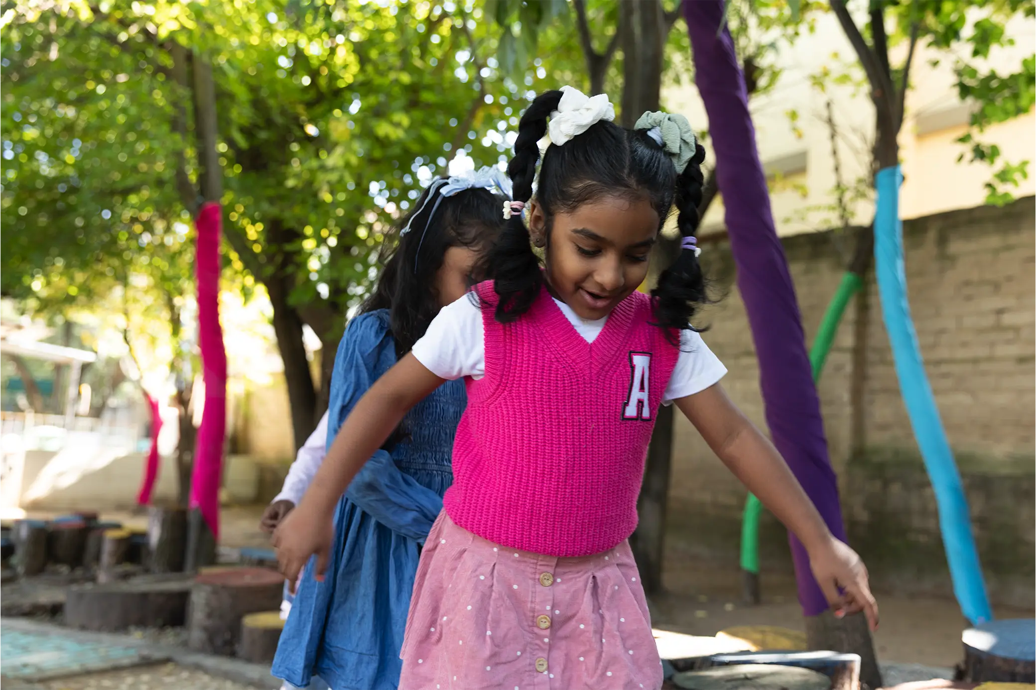 Children exploring the outdoors at Summerhill Nursery