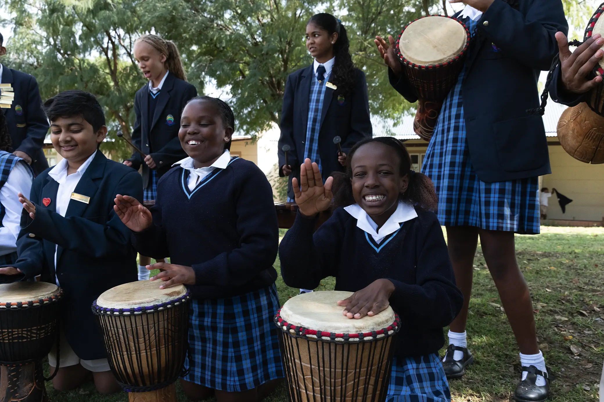 Students playing djembe drums at Summerhill Prep
