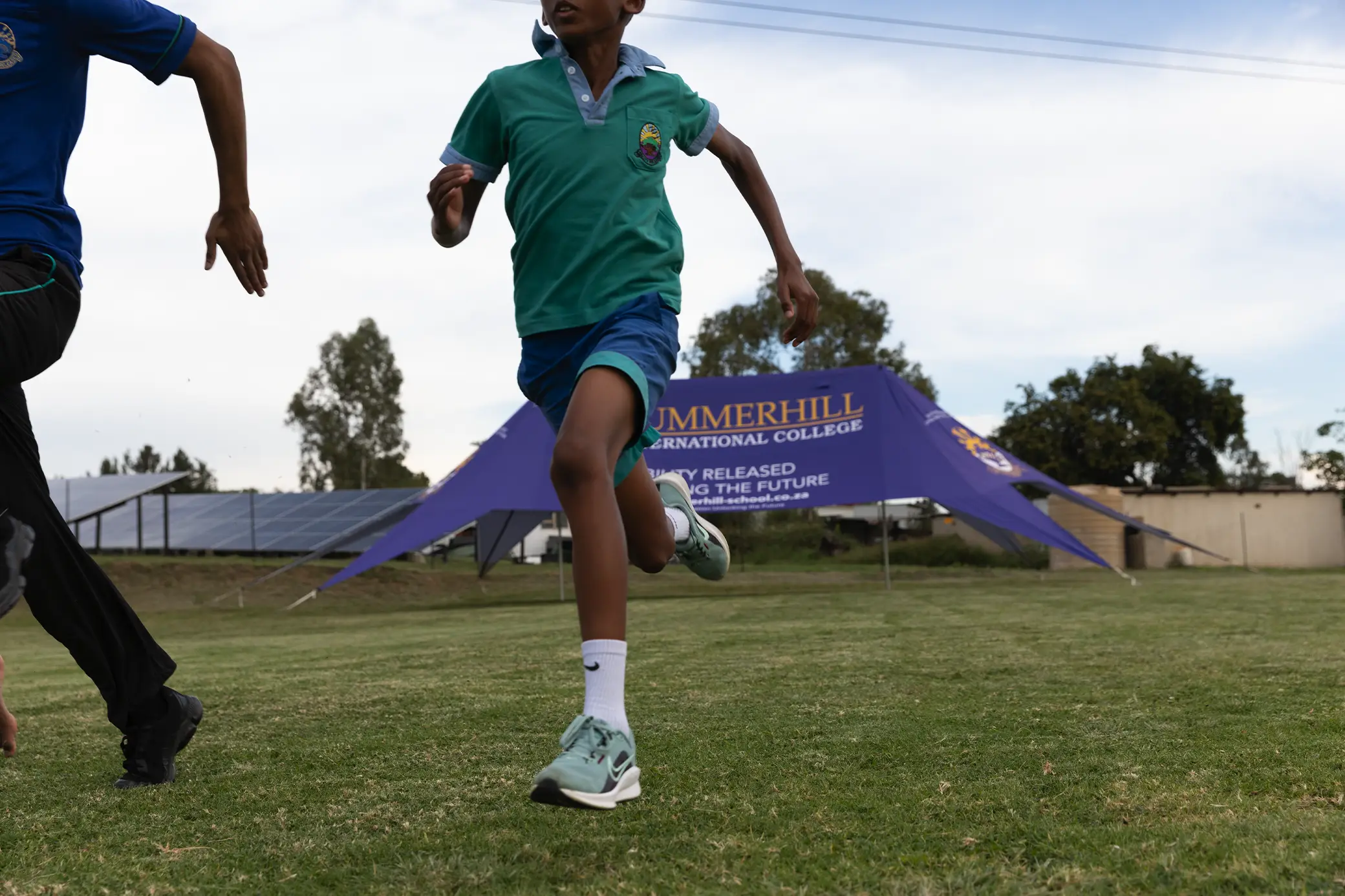 Summerhill students running on the athletics track